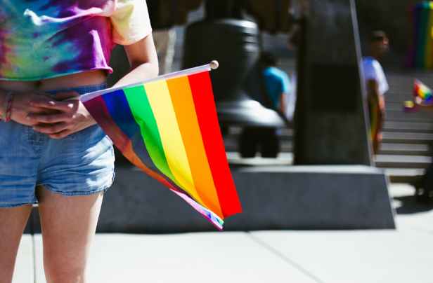 person holding flag close up photography
